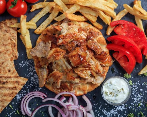 greek-gyros-dish-on-a-black-dish-top-view-PRNA72N